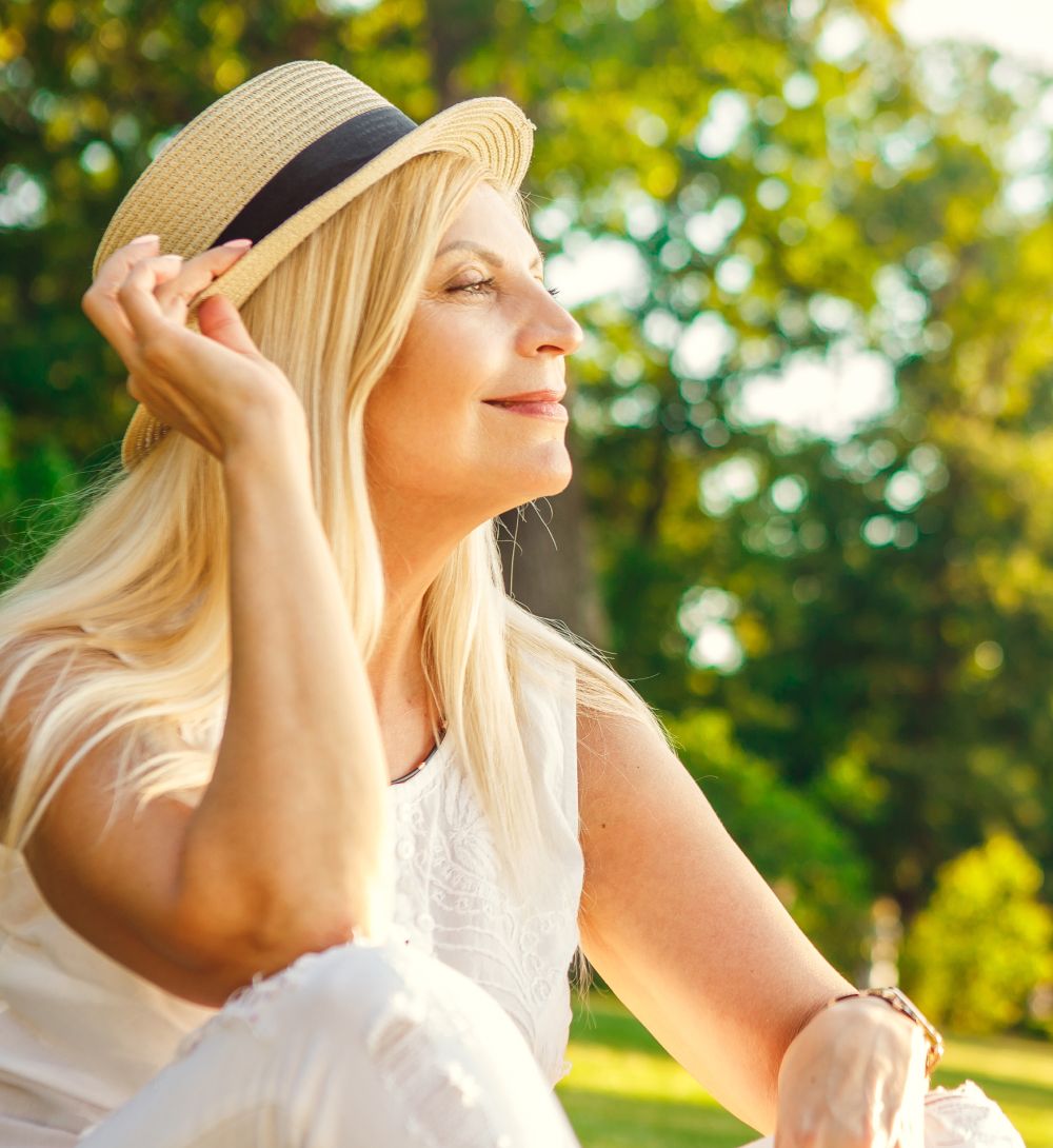 Woman enjoying nature in a sun hat.